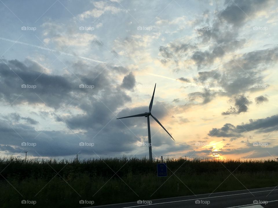 Windmill in cloudy sky 