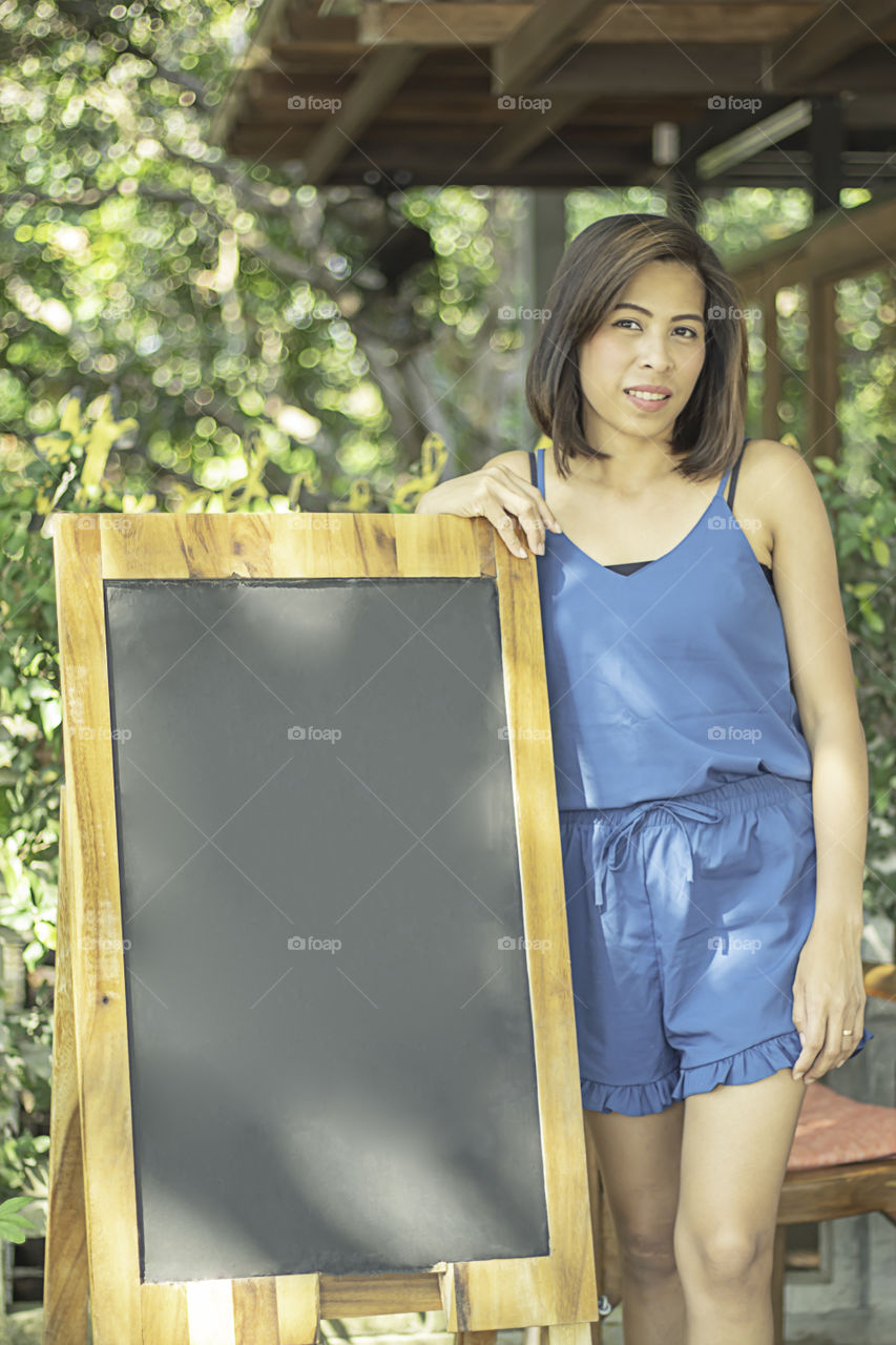 Asian Women with short hair brown skin and Wooden board for the design.