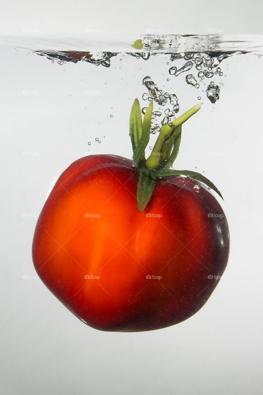 Tomato falling in water