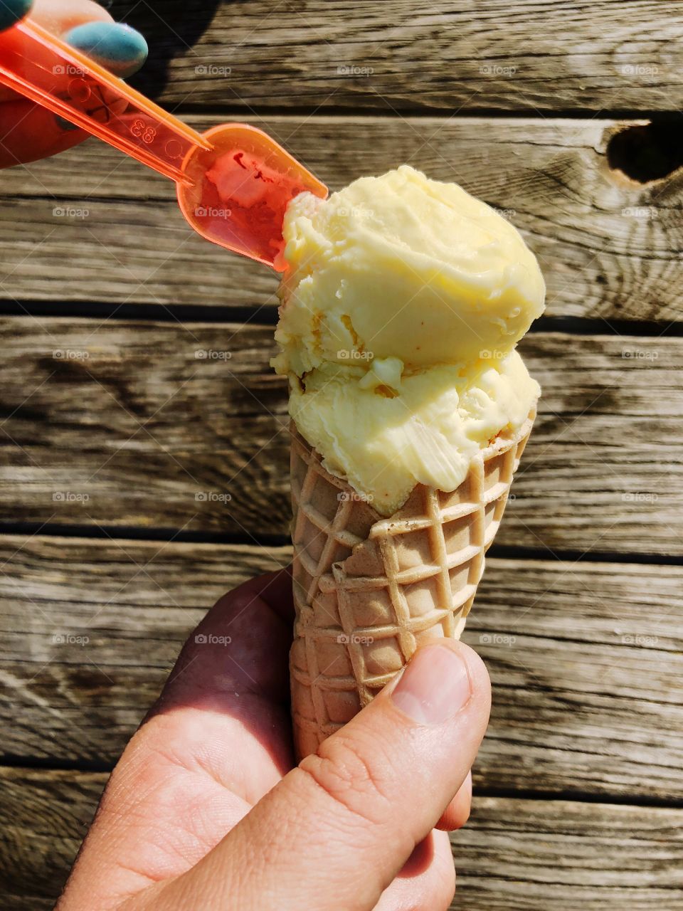 Man and woman eating an ice cream cone