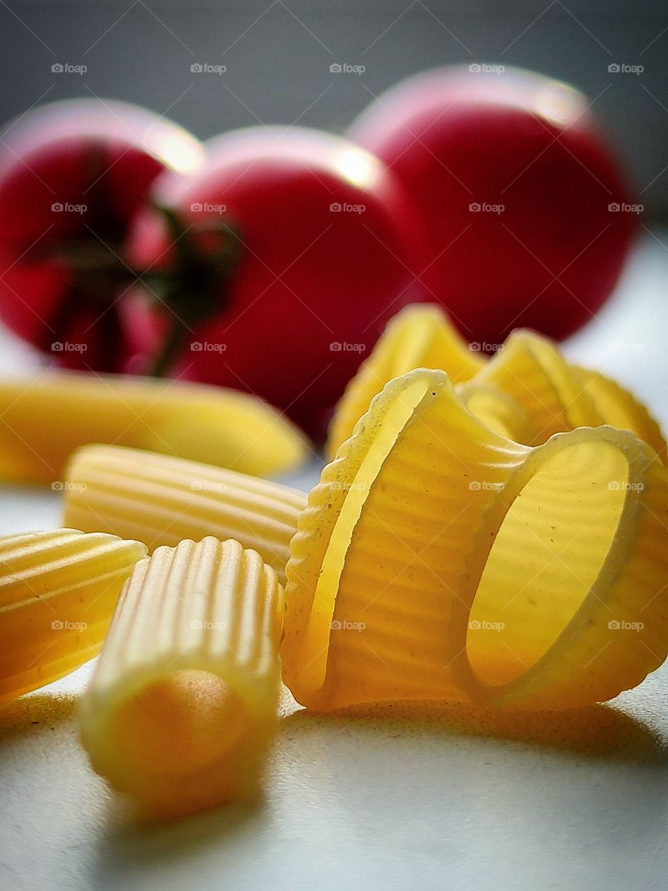 pasta: "PENNE RIGATE" and "PIPE RIGATE" in the foreground.  Red tomatoes in the background