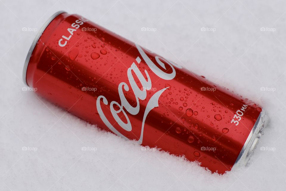 Coca-Cola in a metal can on the snow