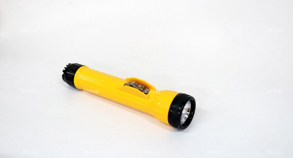 Photo of a yellow flashlight on a white background