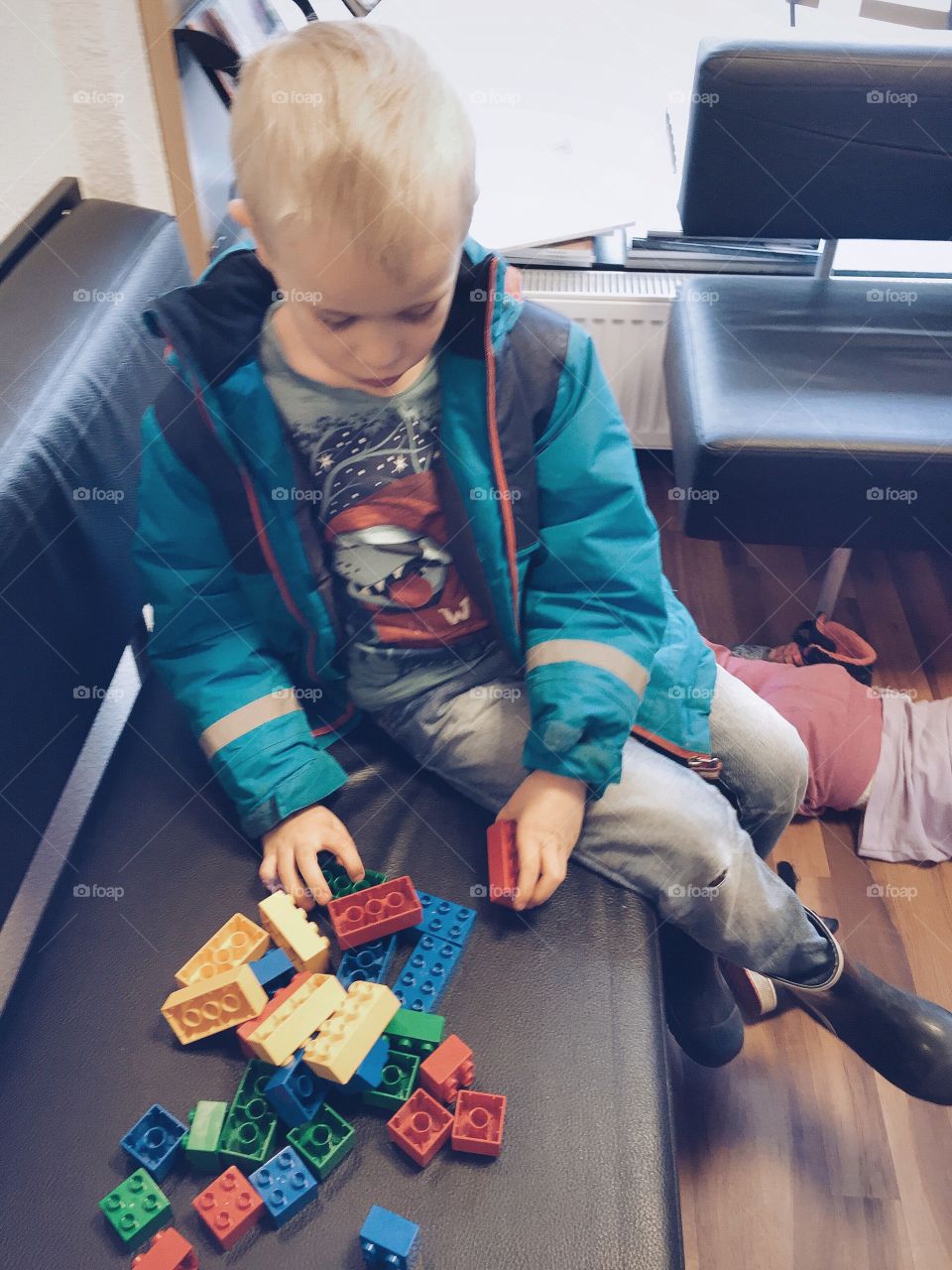 Boy playing with lego in the waiting room