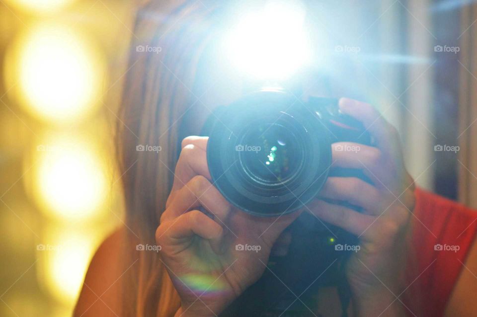 Blonde woman taking photo with Nikon Camera