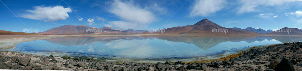 Mountains reflected in a lagoon on Salar de Uyuni in Bolivia