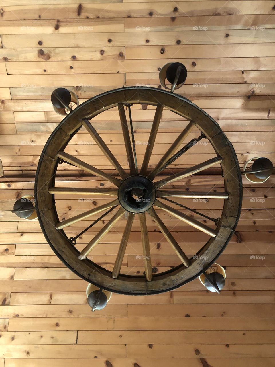 This our light fixture in the main rim at the ranch in Texas, and yes it is a wagon wheel! Looks great against the wood ceiling and I just love it!