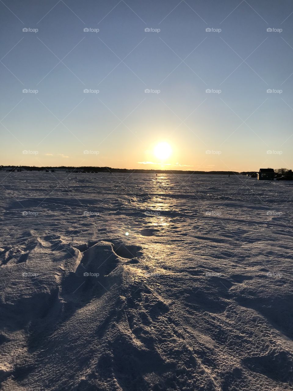 Beautiful winter sunset in a ice fishing day