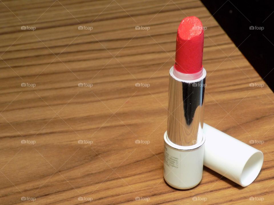 Lipstick on the brown wood table