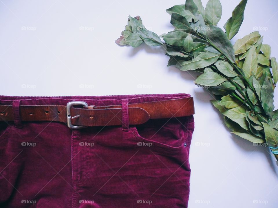 Velvet maroon trousers and bouquet of laurel leaves