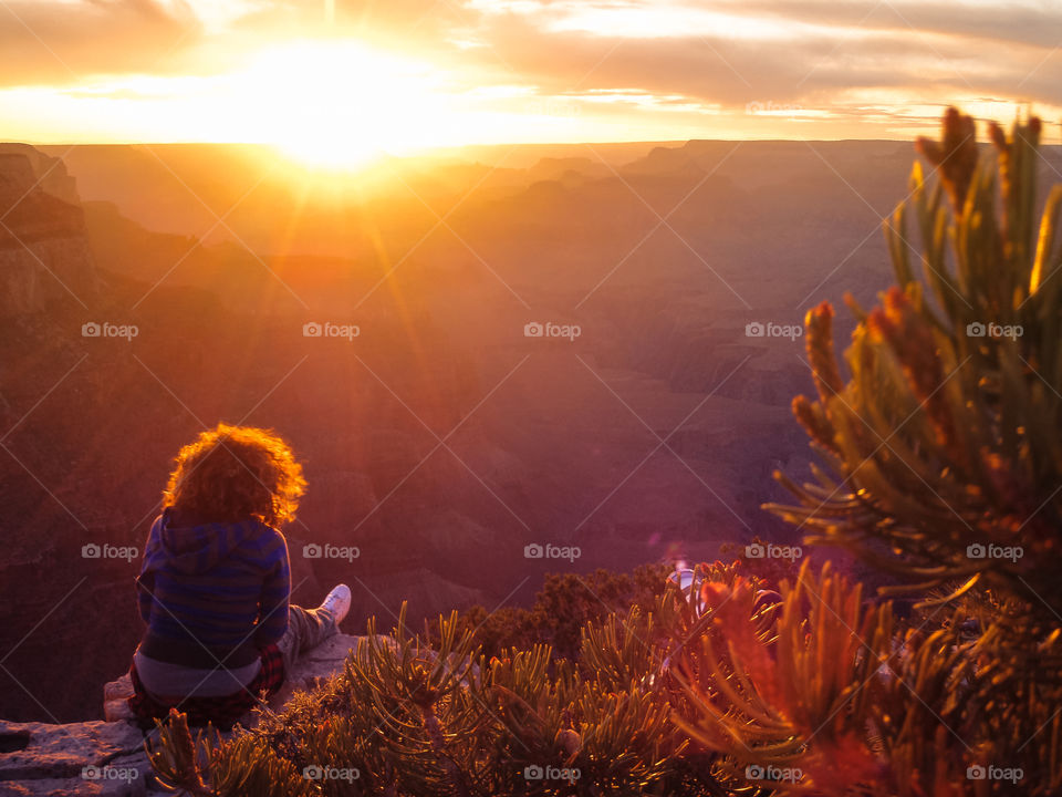 Grand Canyon sunset . Women sitting on a cliff watching the sunset at the Grand Canyon 