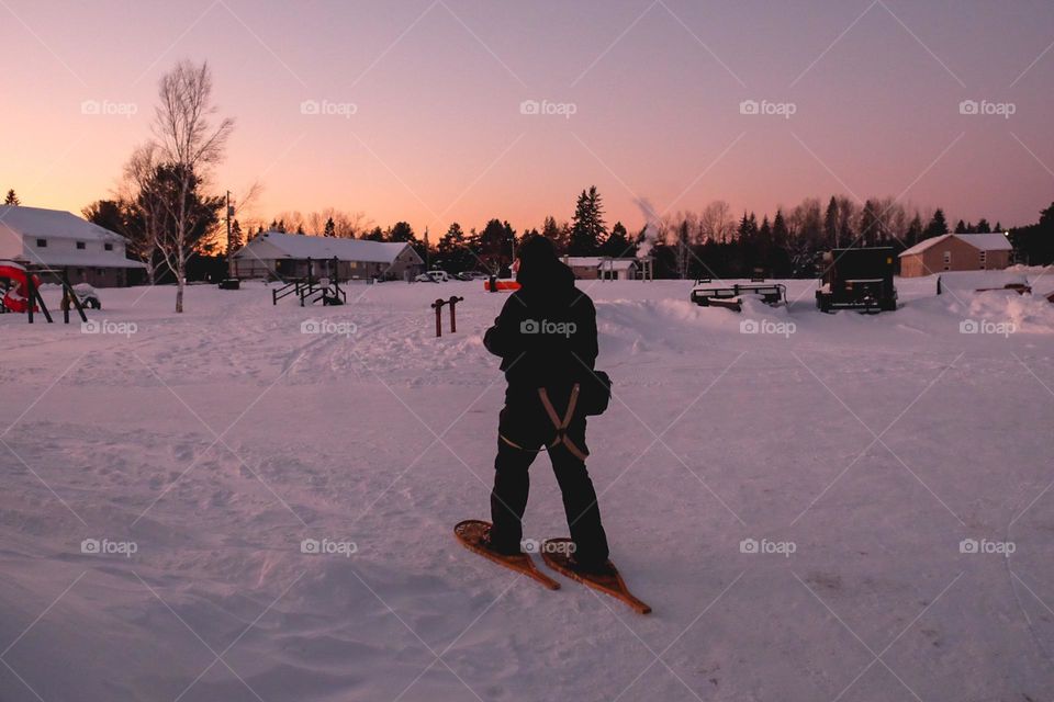 Northern Ontario Canada snowshoeing through frozen cold white snow on winter day