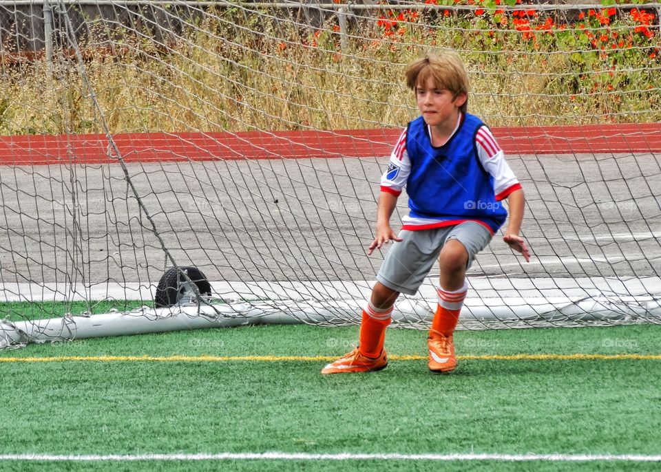 Young Soccer Goalie. Young Boy Guarding The Goal
