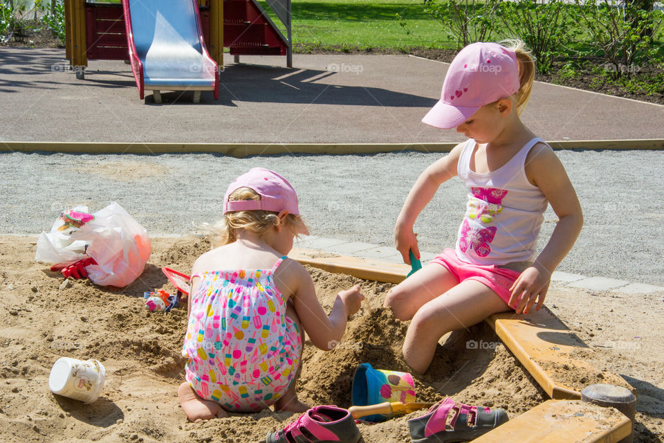 Two young sister is playing at a playground in Malmö Sweden.