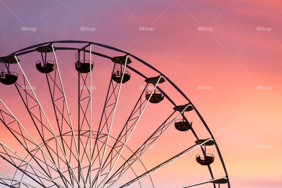 Giant ferris wheel against colorful sunset
