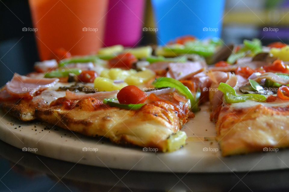 Colourfull pizza with drink cups 