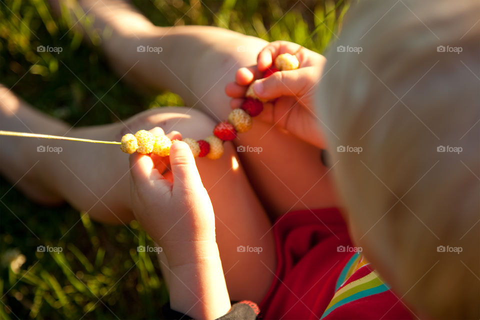Little boy holding wild strawberries