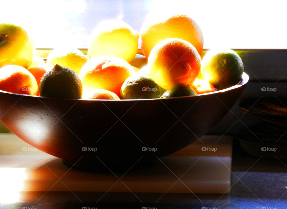 Bowl of back lit Citrus. Lemons and limes. 