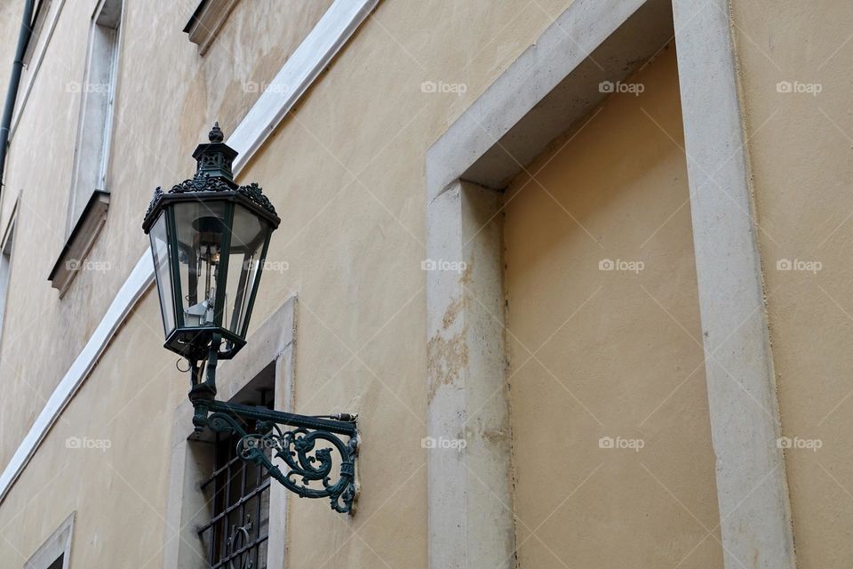 Old decorated street lamp on a house in the historical center of Prague, Czech Republic.