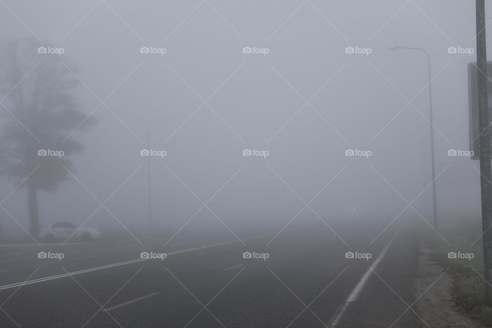 endless empty asphalt road with fog