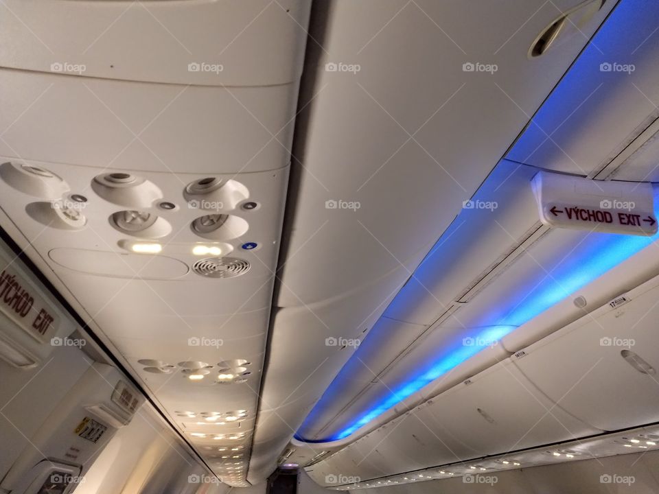Inside airplane. Blue light.