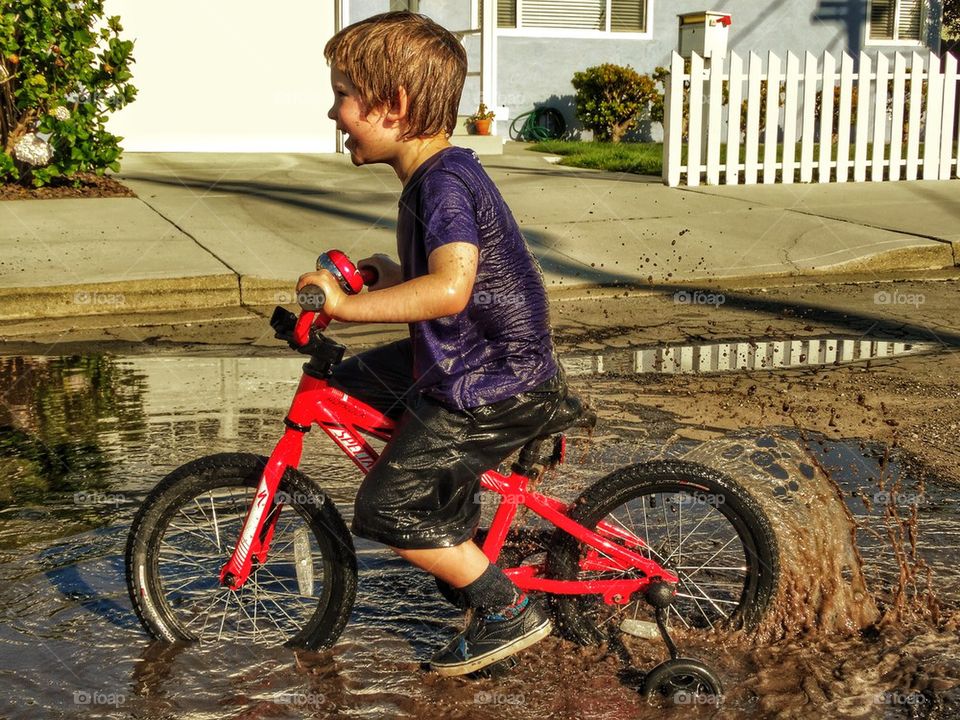 Boy Playing In Mud
