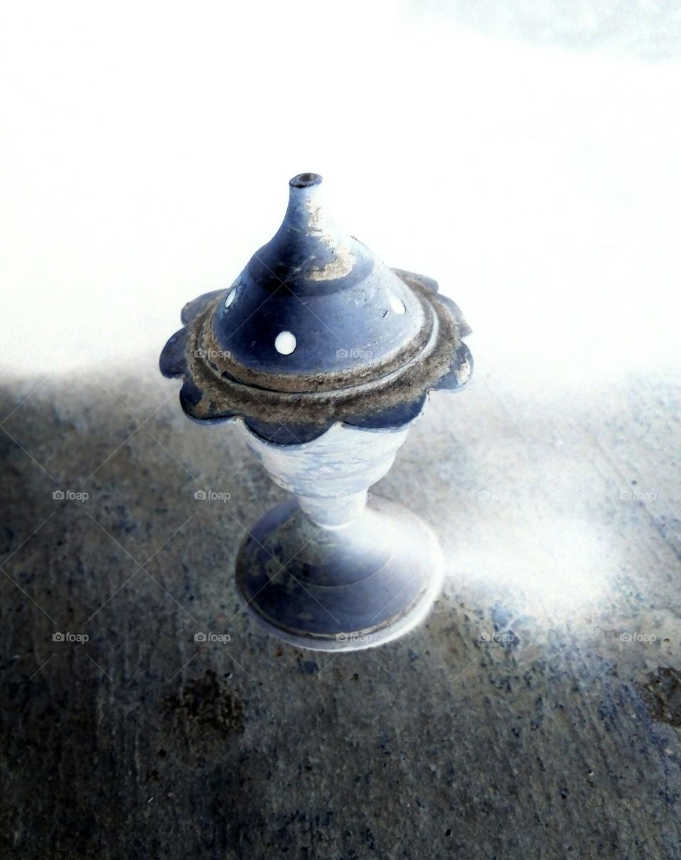 Photo of an old Agarbatti stand / Photo of an ancient Agarbatti stand / Photo of Agarbatti stand used in worship / Photo of Indian Agarbatti stand / Negative photo of Agarbatti stand / Photo of brass Agarbatti stand