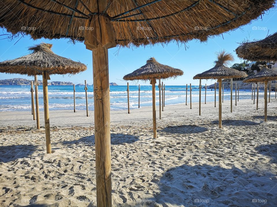 Sunny vacation beach with parasols