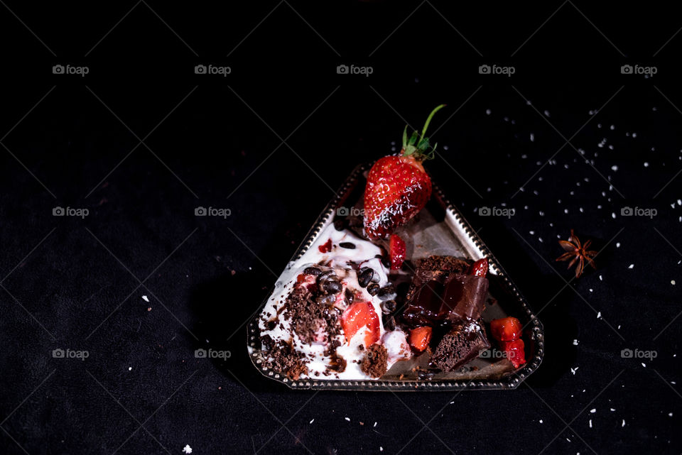 Ice cream with chocolate and strawberries