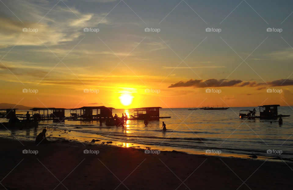 Scenic view of sea against orange sky
