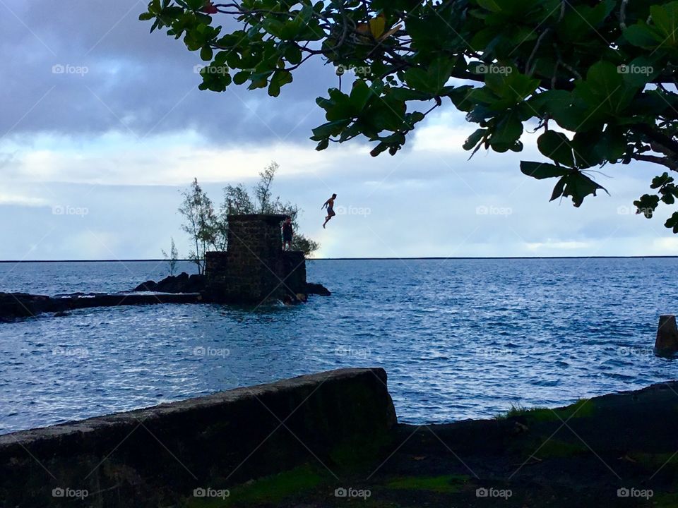 Boys jumping in Hilo Bay