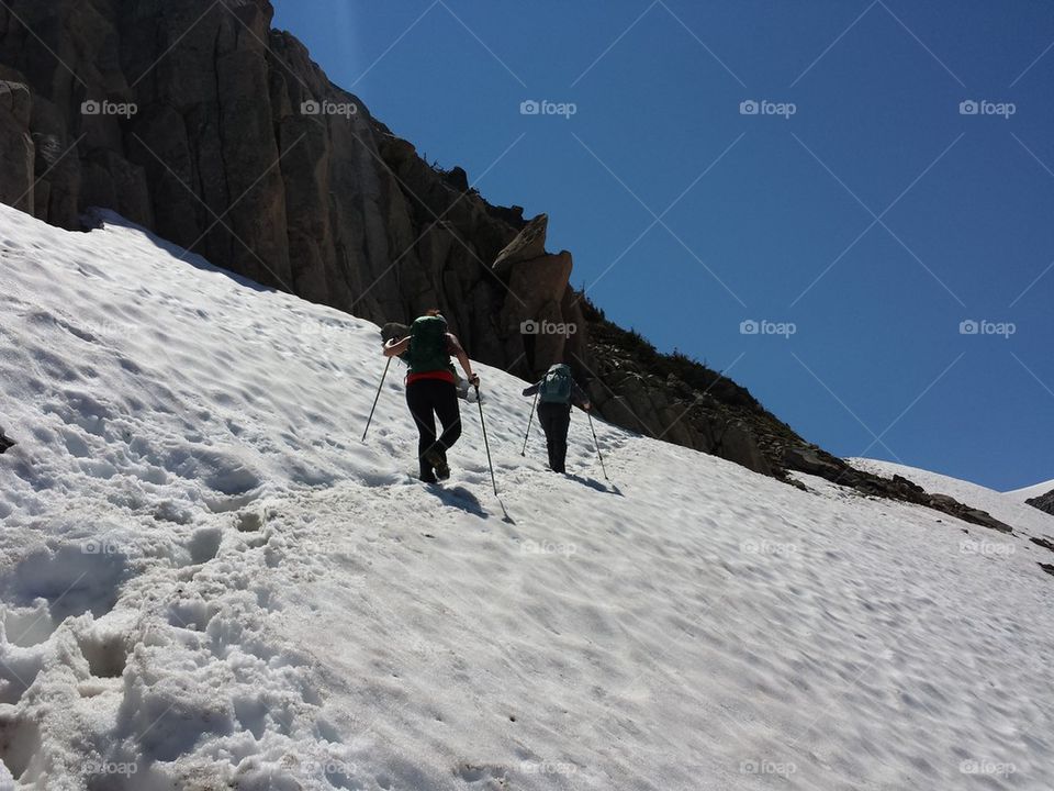 hikers crossing snowfield