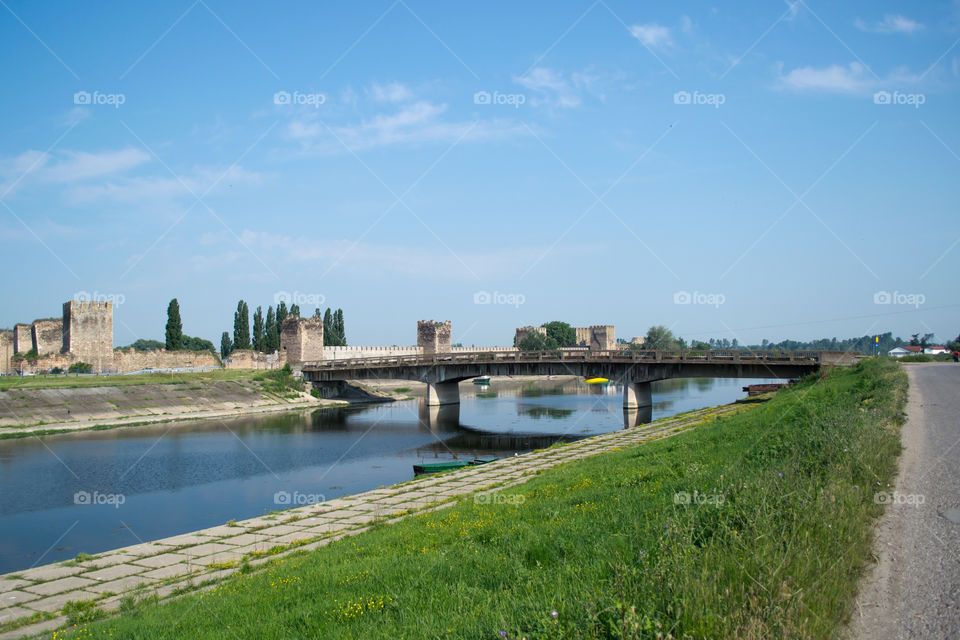 Stone bridge near the fortress. It is closed for cars. Only for people walk. Old stone bridge on the river.