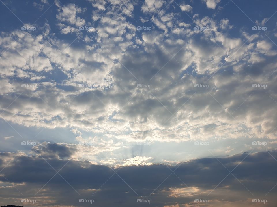 clouds flying with sunrays.