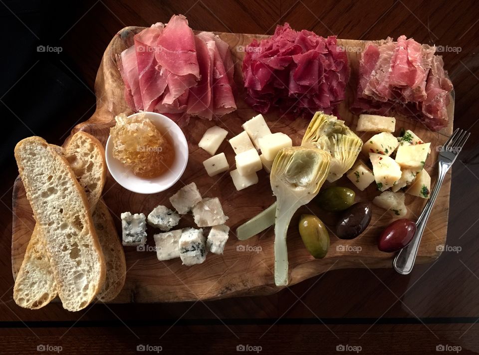 Anti pasto. Wooden board with variety of antipasti