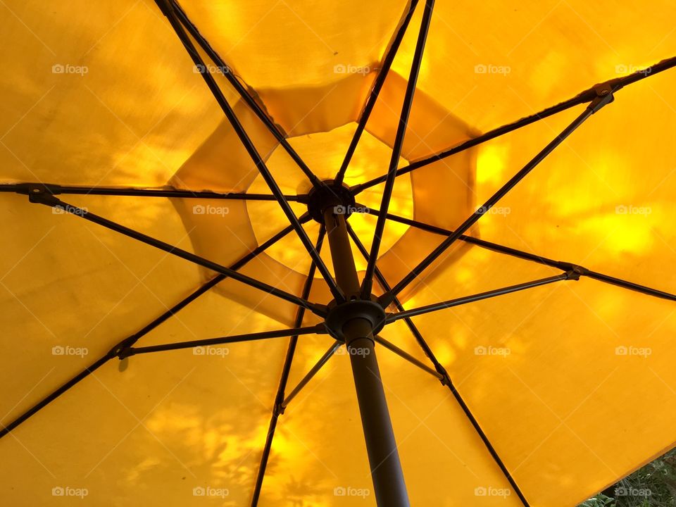 Yellow umbrella outside Taco Norteno with shadows 