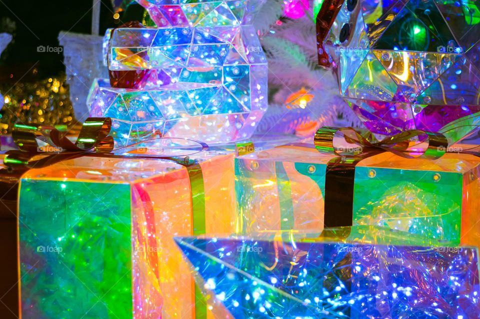 multi-colored boxes of New Year's gifts and different garlands of different colors