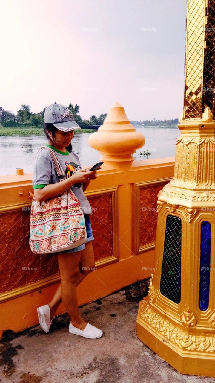 woman
one
phone
river
tree
wat
temple