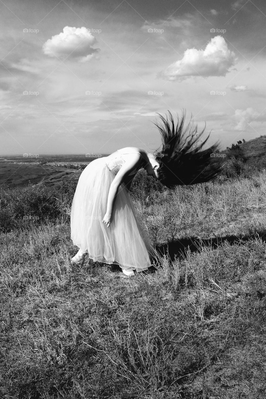 Girl in a dress dancing on the mountain