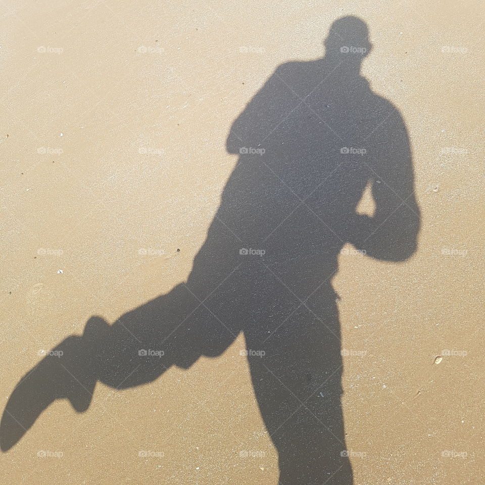 in the picture is my self shadow dancing on the sand . the golden sand