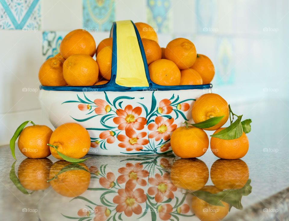 Fruit bowl full of clementines in blue kitchen