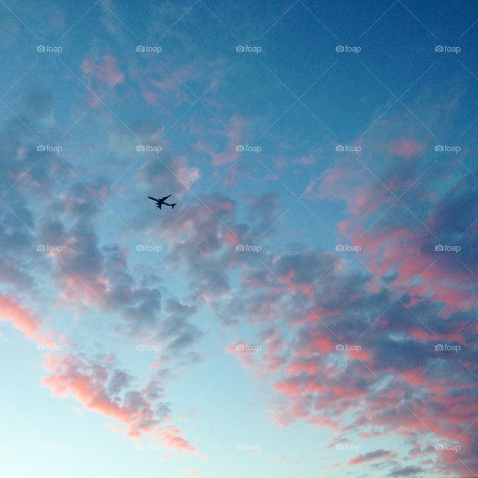 Destination Unknown. Pink clouds and plane