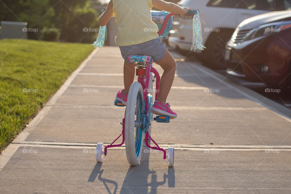 Toddler Girl Riding a Bicycle for the First Time