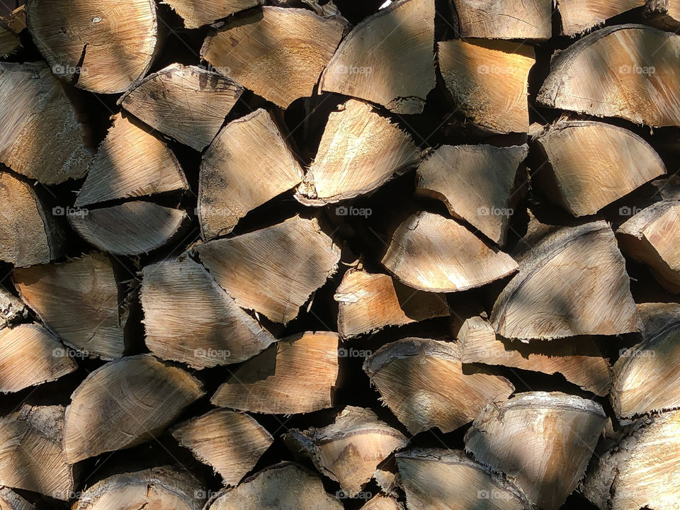 Stack of wood in light and shade 