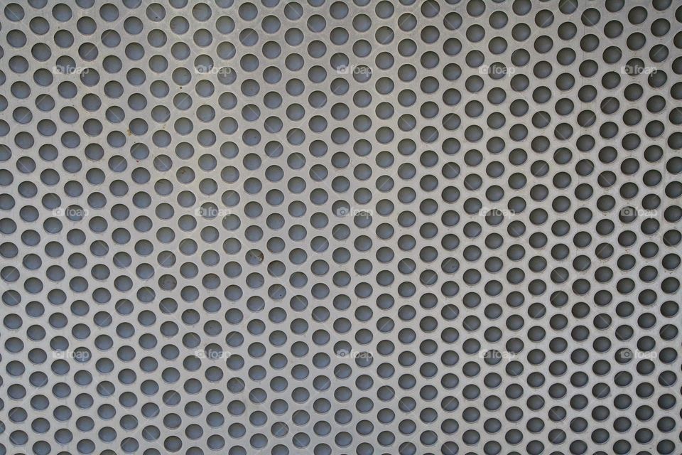 A perforated metallic symmetrical abstract
