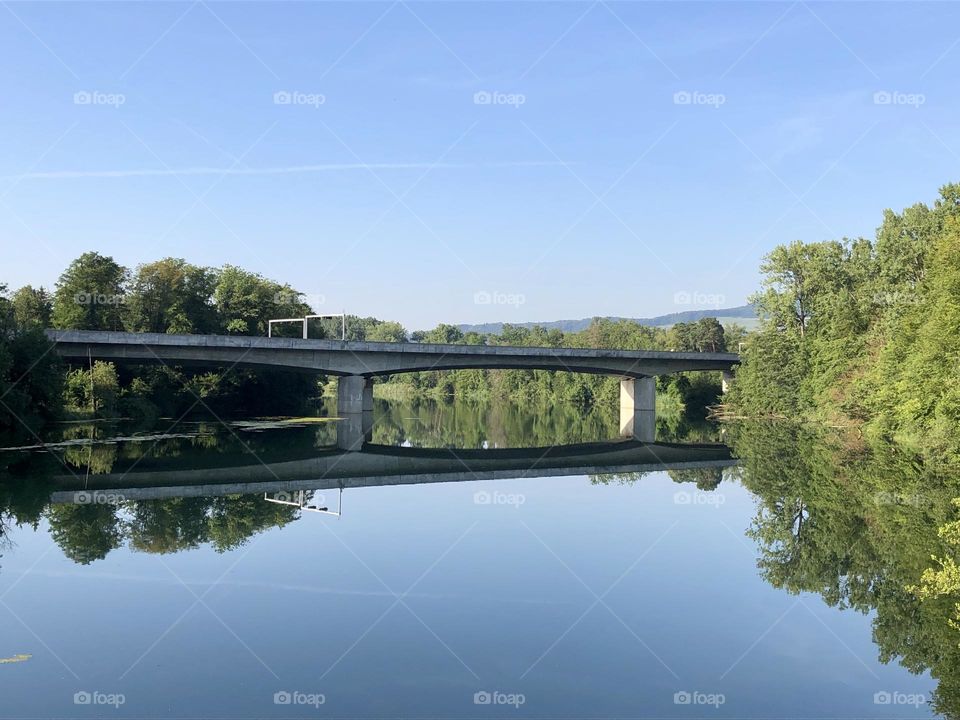 Bridge reflected in calm river water
