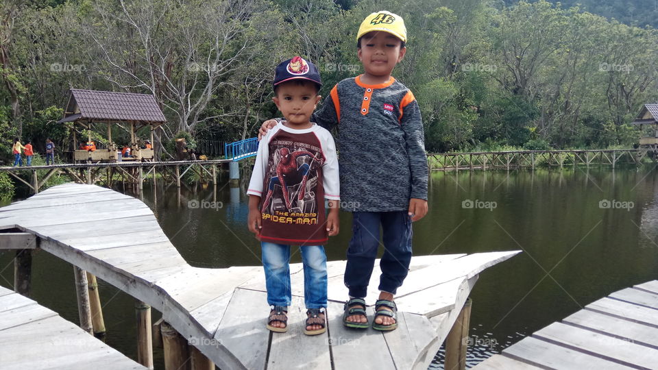 Two Children Holiday in Banto Royo Playground, located in Jorong Kaluang Tapi, Nagari Koto Tangah, District Tilatang Kamang, Kabupaten Agam, West Sumatra, Indonesia.
