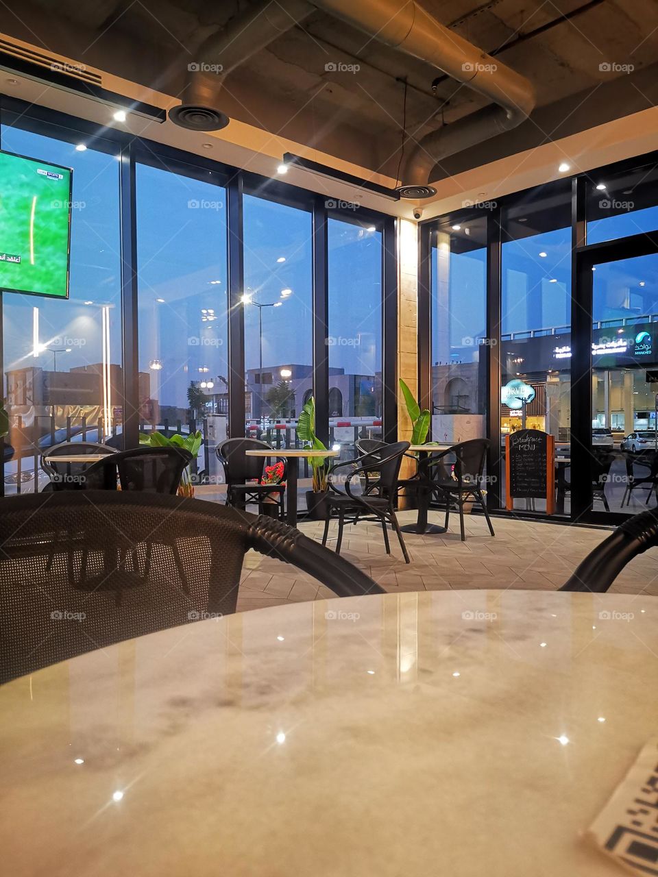 Waiting for black coffee in the café at sunset