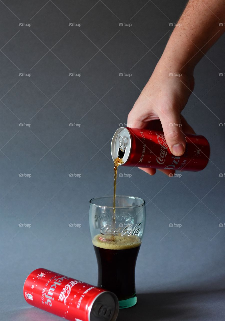 pouring cola in glass