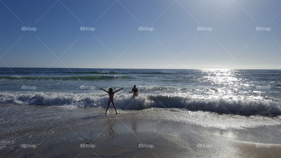 Swimmers play in the ocean near San Diego, California.
